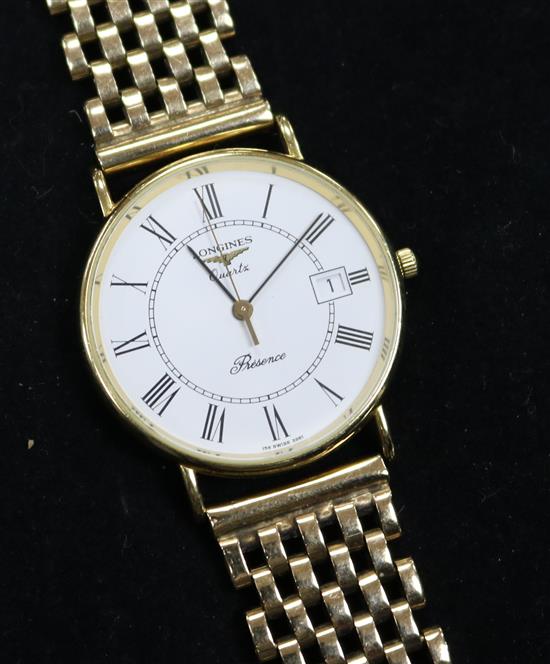 A gentlemans 9ct gold Longines quartz wrist watch on an associated 9ct gold bracelet.
